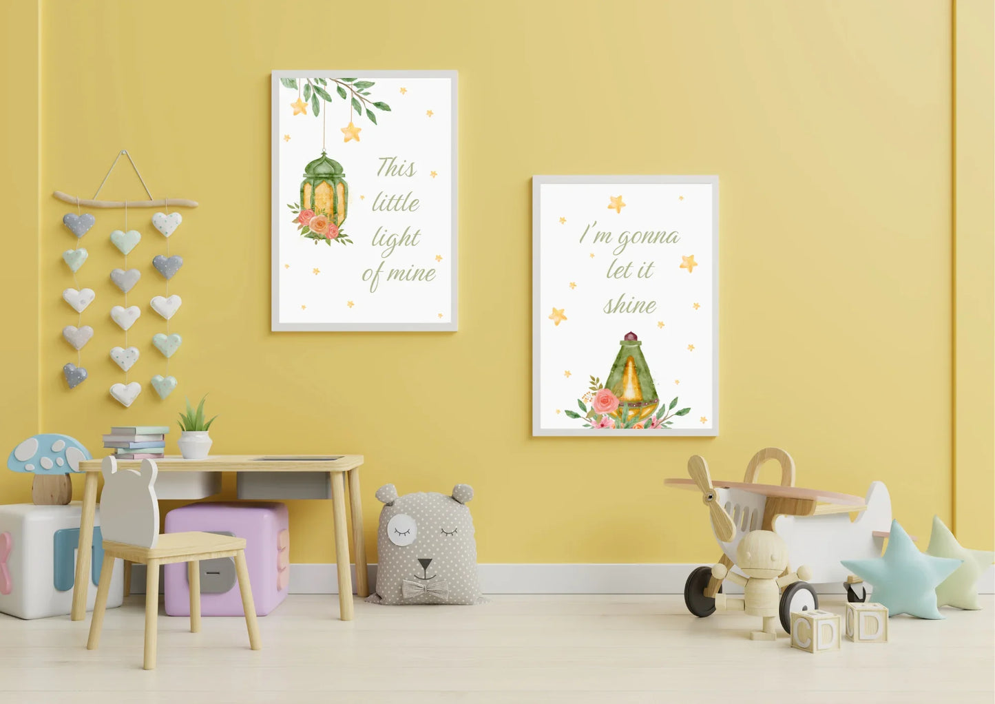 Children's room with yellow walls, toys, and two Christian framed prints.