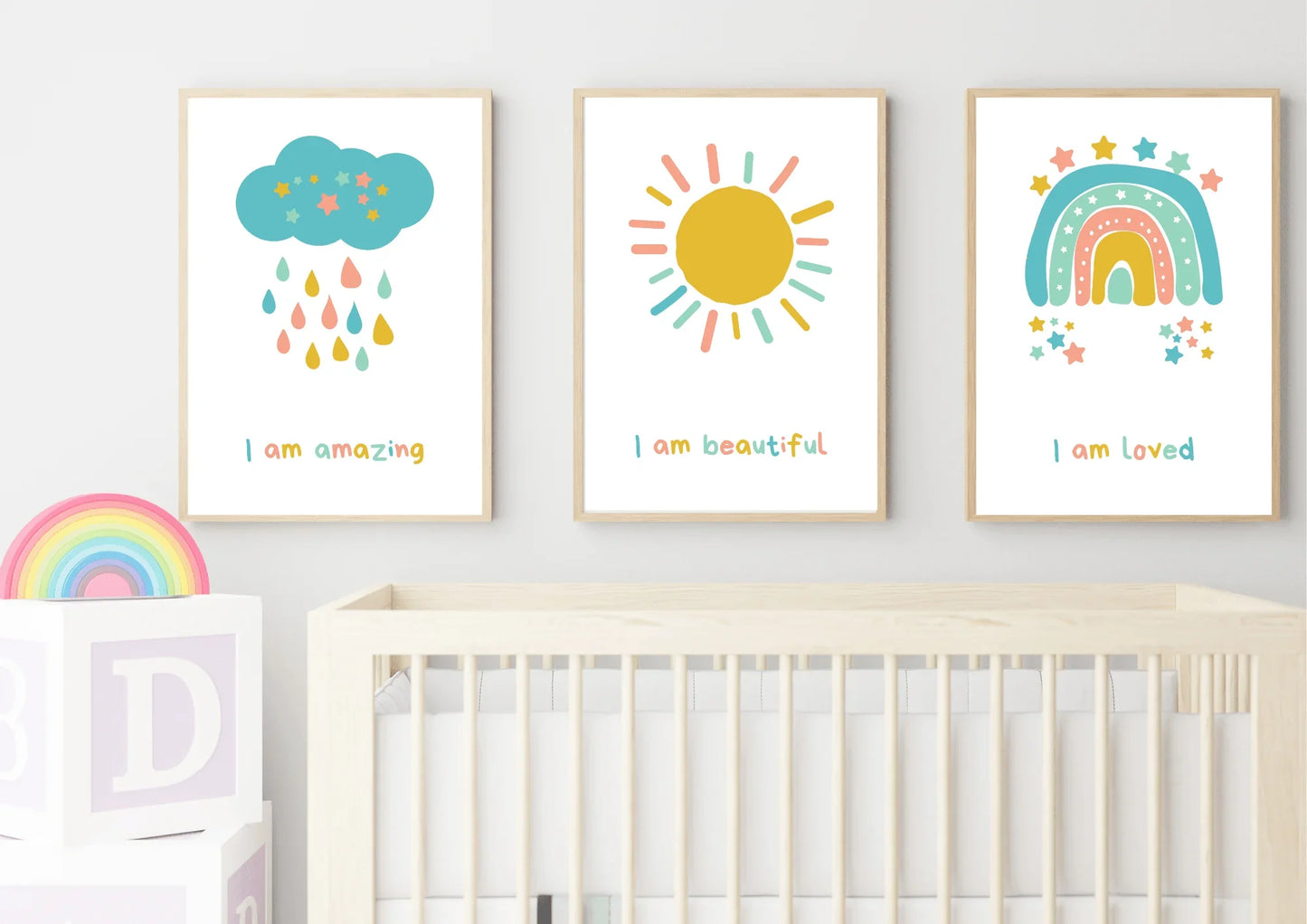 set of three nursery prints, featuring a cloud, rainbow, and a sun with positive affirmations