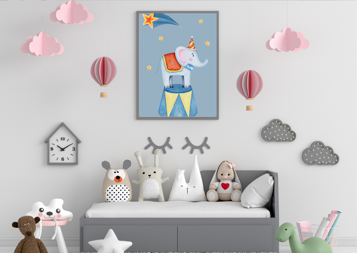 Children's room with a framed picture of an elephant, colorful wall stickers, and toys on a gray bed.