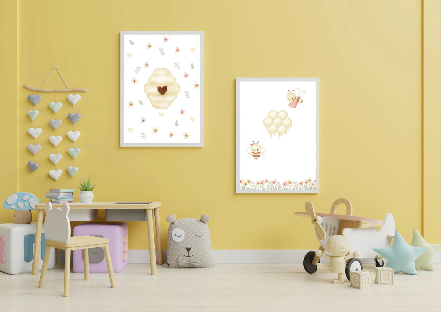 Children's room with yellow walls, framed artwork, and toys.