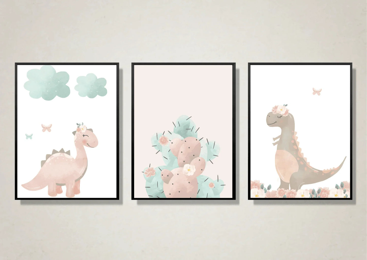 Three framed watercolor prints featuring a pink dinosaur with clouds, a pastel pink and mint cactus, and a floral brown dinosaur.
