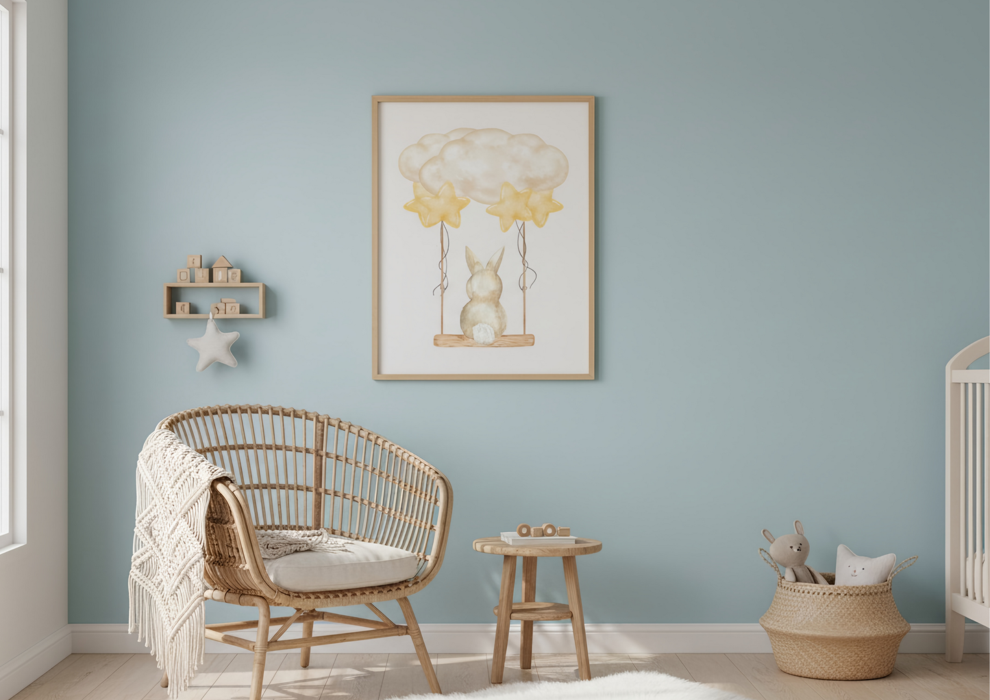 Nursery room with wicker chair, wooden table, and framed artwork on a light blue wall.