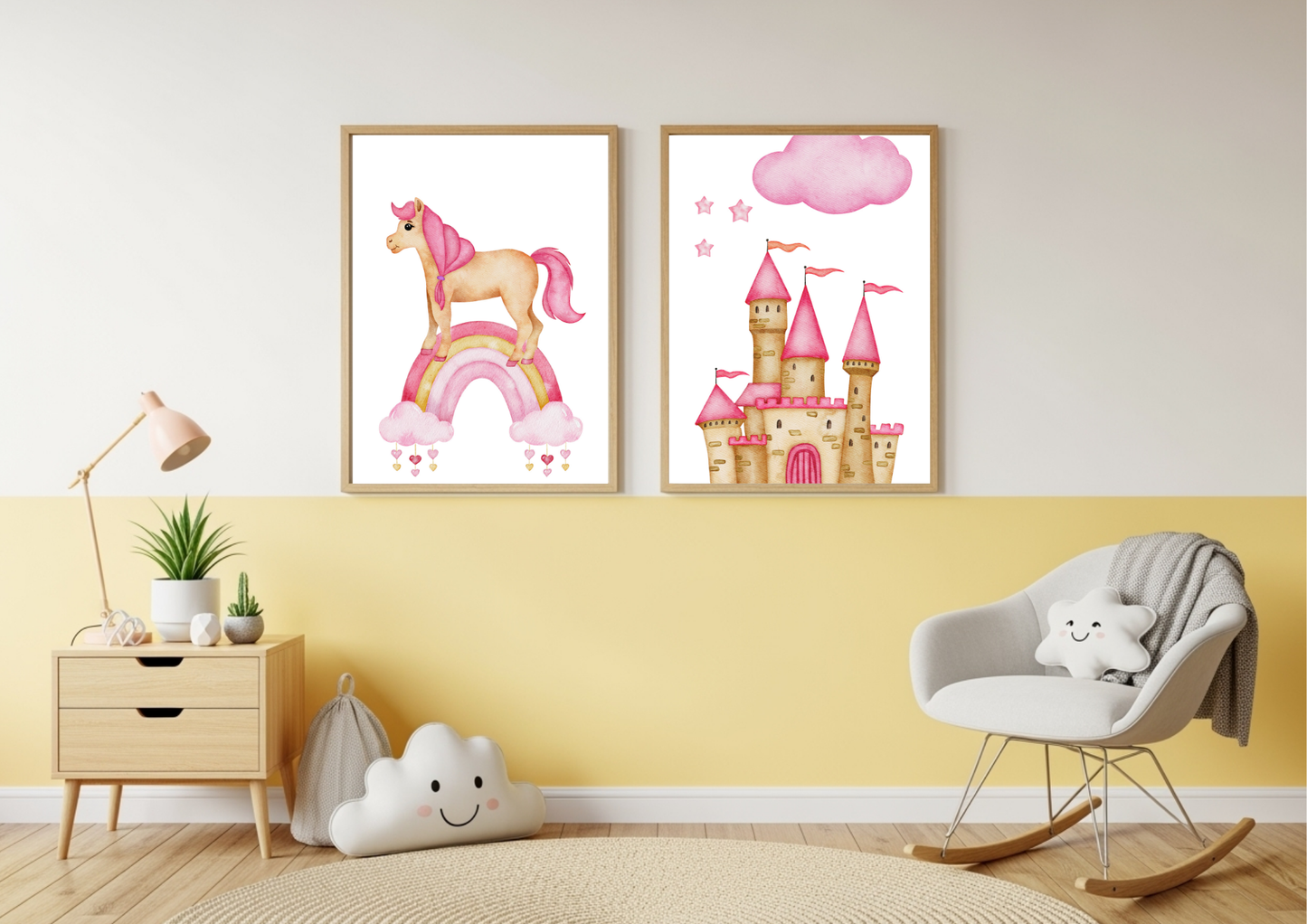 Two framed watercolor prints, one featuring a unicorn on a rainbow and the other a pink princess castle, hang on a wall split between yellow on the bottom and white on the top. To the left is a wooden nightstand with a lamp and a plant. To the right is a white rocking chair with a cloud-shaped pillow.