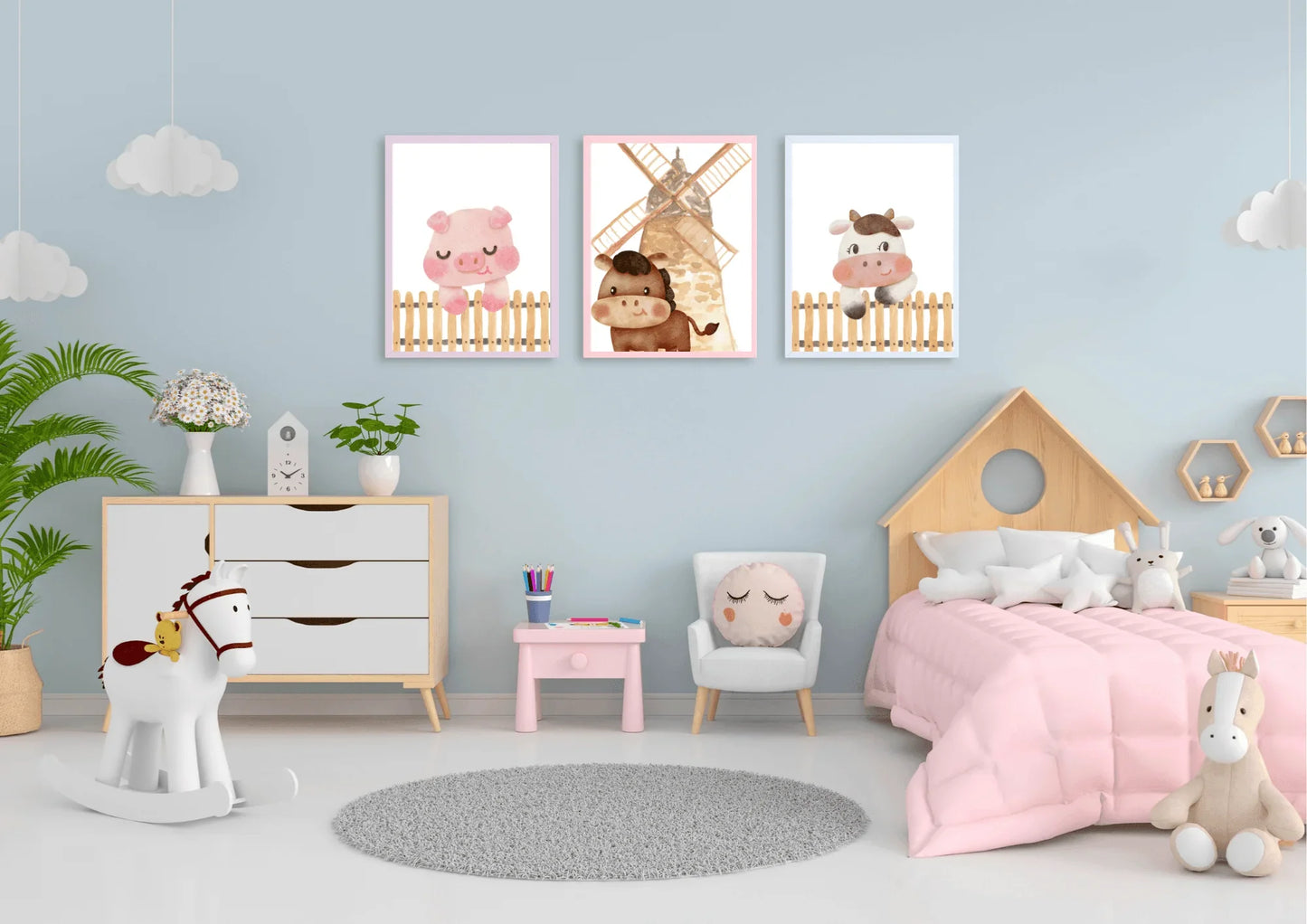 Three framed watercolor farm animal prints (pig, horse, cow) with pink borders on a light blue wall above a dresser and a child's bed with pink bedding.