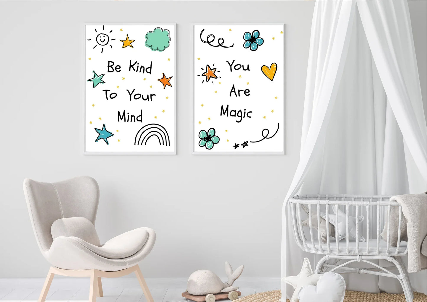 A two-panel set of framed digital art prints with motivational quotes, hanging on a white wall. The left print says "Be Kind To Your Mind" and the right one says "You Are Magic." A plush chair and a white baby crib with a canopy are in the room.