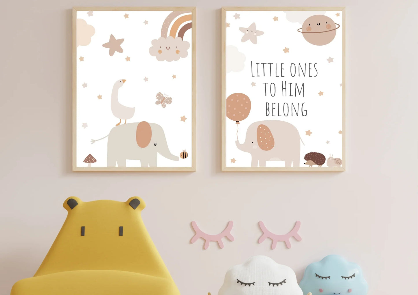 A set of two framed art prints of a goose, elephant, and hedgehog with the quote "Little ones to him belong" on a pink wall in a nursery.