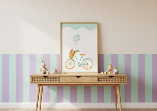 Framed artwork of a bicycle with balloons on a wall with striped wallpaper.
