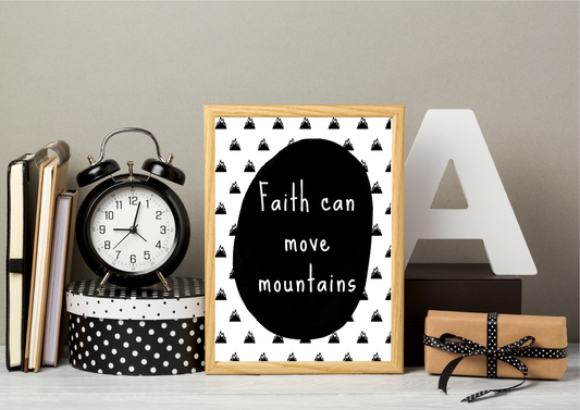 Decorative setup with a black and white religious nursery print, clock, books, and gift box on a neutral background