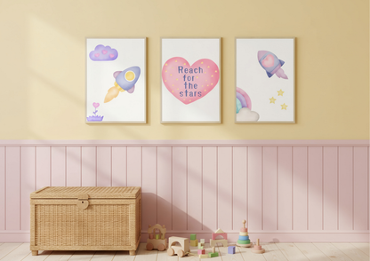 Three colorful wall art prints on a yellow wall with a wicker chest and toys below.