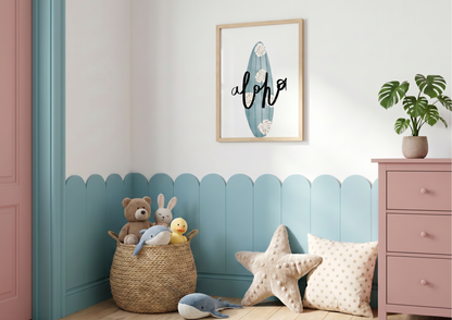 A cozy nursery corner featuring light blue scalloped wainscoting that matches the turquoise surfboard art hanging in a wooden frame above. A large woven basket is filled with plush toys, including a teddy bear and a duck, while a textured starfish pillow and a polka-dot cushion rest on the floor nearby. To the right, a muted pink dresser holds a small potted Monstera plant, adding a touch of greenery to the bright and airy space.