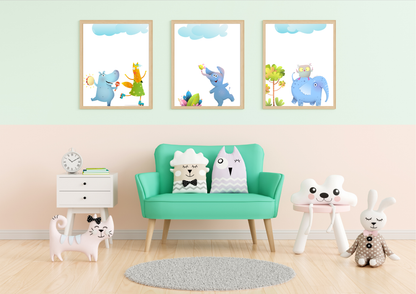 
A set of three framed animal art prints with wooden frames on a two-toned wall in a playroom with a mint green armchair.