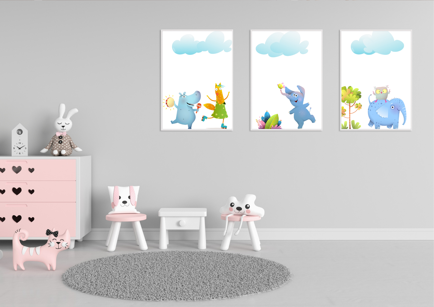 A set of three whimsical animal art prints in white frames on a gray wall in a child's playroom with a pink dresser.