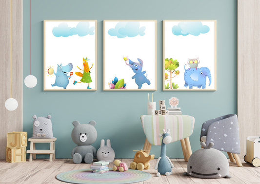 A set of three whimsical animal art prints with wooden frames on a light blue wall in a playroom with a rainbow rug.