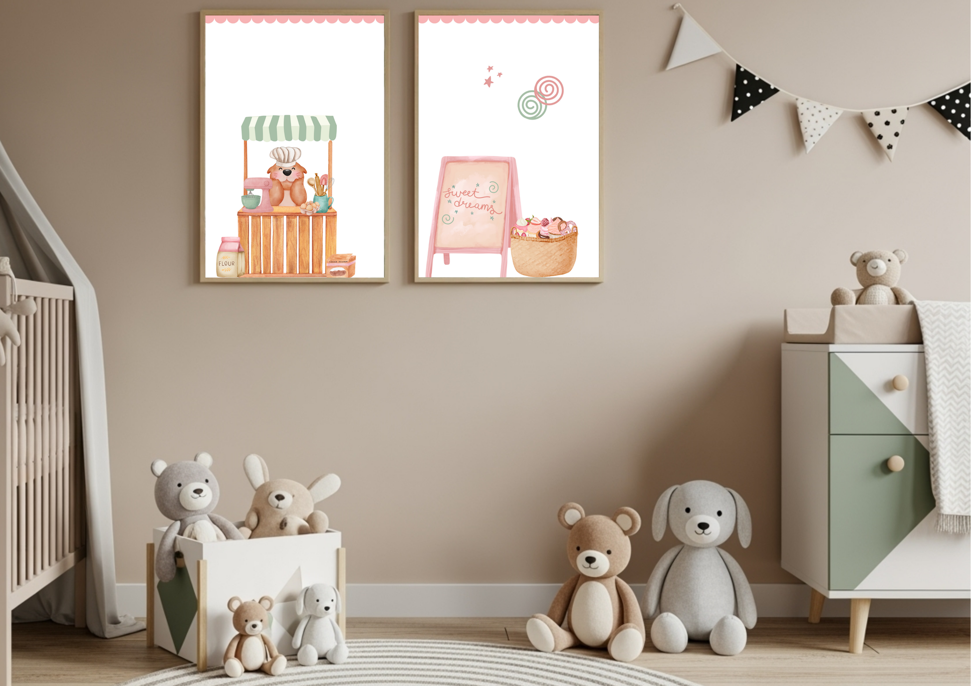 Two framed nursery prints on a beige wall above a toy-filled playroom. The left print shows a cute bear baker behind a wooden market stall with a striped awning. The right print features a pink "Sweet Dreams" sign next to a basket of colorful cupcakes and treats.
