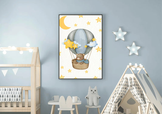 Framed bear hot air balloon wall art in a blue themed baby room next to a wooden toddler bed and a canvas play tent.