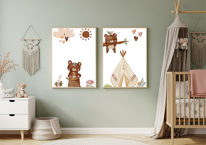 A set of two framed Aztec tribal woodland bear nursery prints hanging on a sage green wall, styled above a crib with a boho canopy and next to a white dresser with a teddy bear and macrame wall hangings.