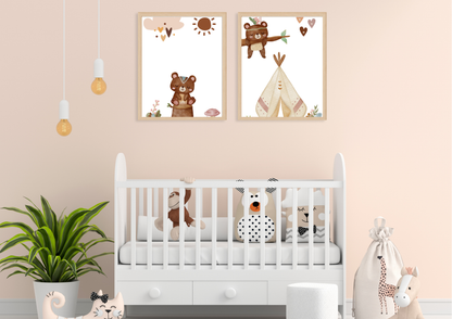 A neutral-toned nursery with soft peach walls. Two framed Aztec tribal woodland bear prints hang above a white wooden crib, which is decorated with playful black and white animal pillows. A large green houseplant sits to the left.