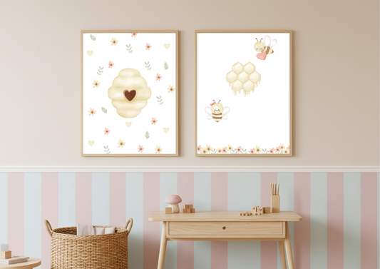 Two bee themed framed artworks on a wall with striped wallpaper below.