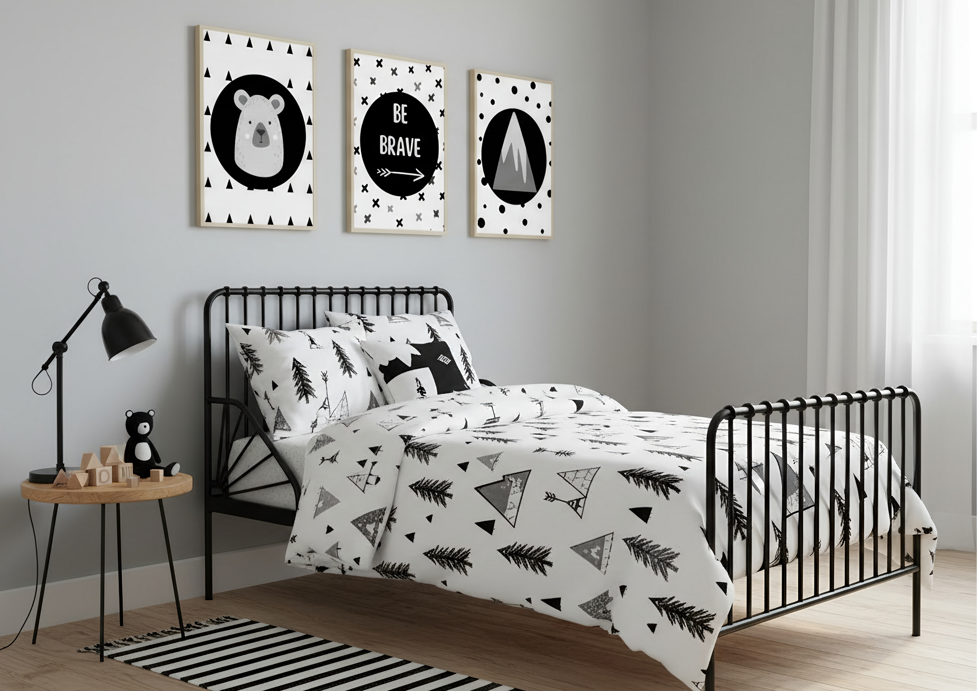Bedroom with black metal bed, white bedding with black patterns, and wall art.