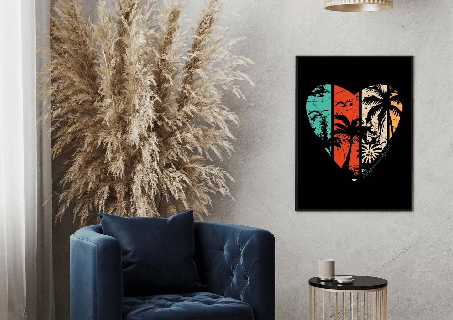 Framed artwork with a heart design featuring palm trees and a sun, placed on a wall above a blue armchair.