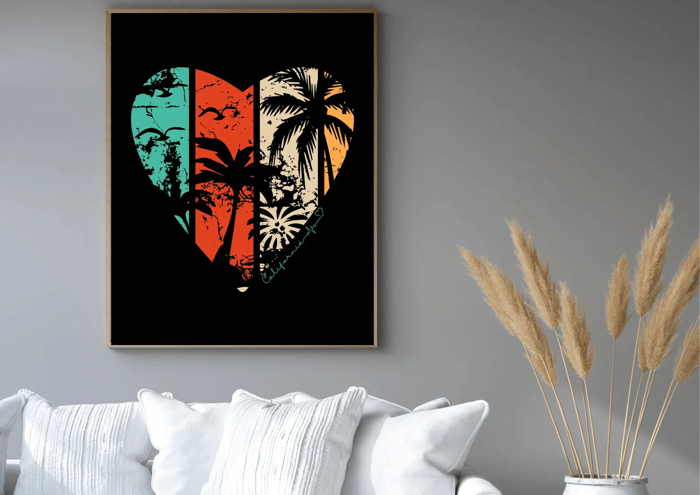 Framed artwork with a heart design featuring tropical elements on a gray wall above a white sofa.