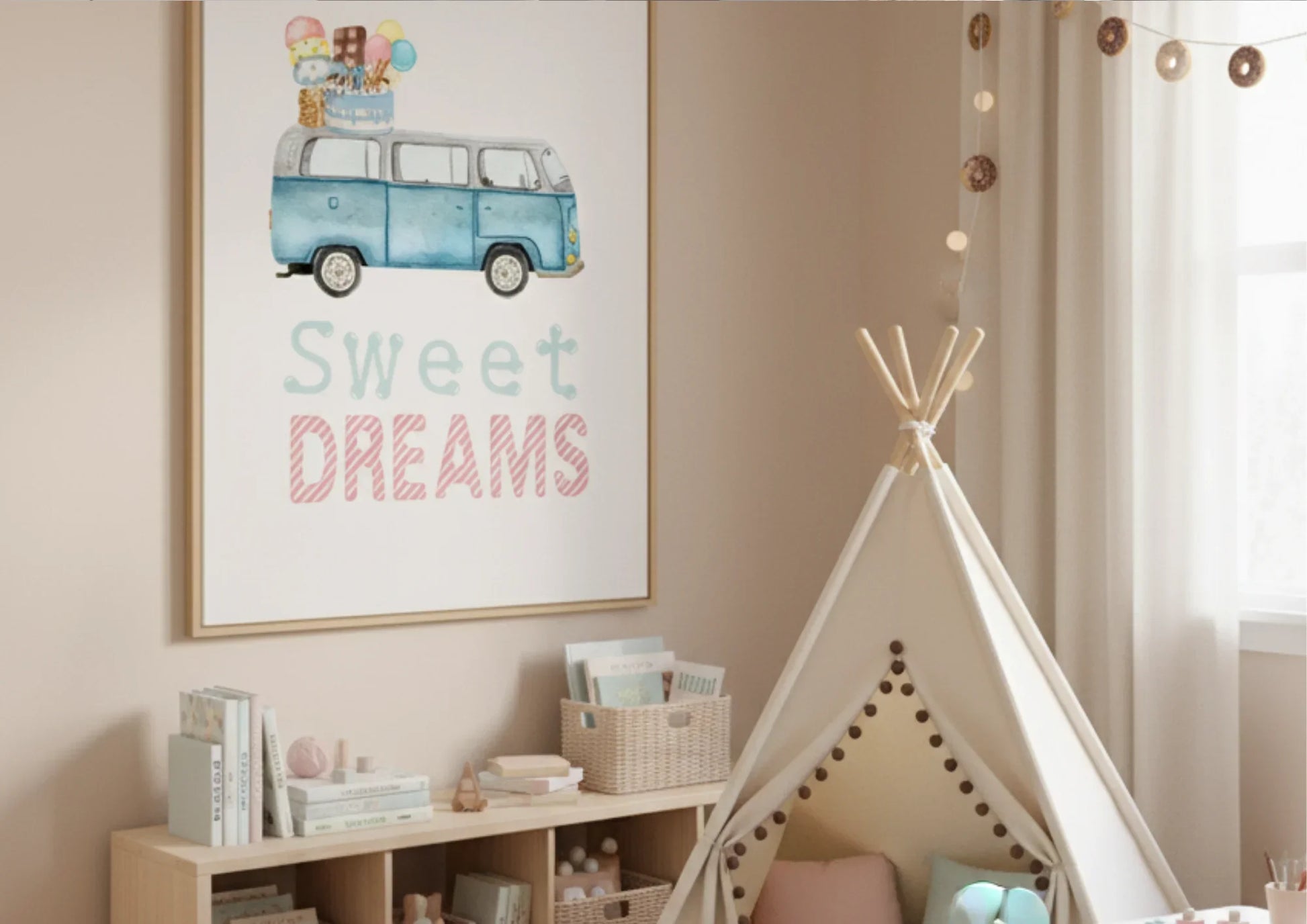 A close-up shot of a cozy corner in a child's room with soft beige walls. On the left, a framed watercolor print hangs, featuring a light blue, vintage Volkswagen van (VW bus) with a stack of ice cream cones, popsicles, and a birthday cake on its roof. The text below reads "Sweet DREAMS" in a playful light blue and pink font. Below the art, a light wood cubby shelf is filled with books, small toys, and baskets. To the right of the shelf, a neutral-colored canvas teepee with wood poles stands, decorated with