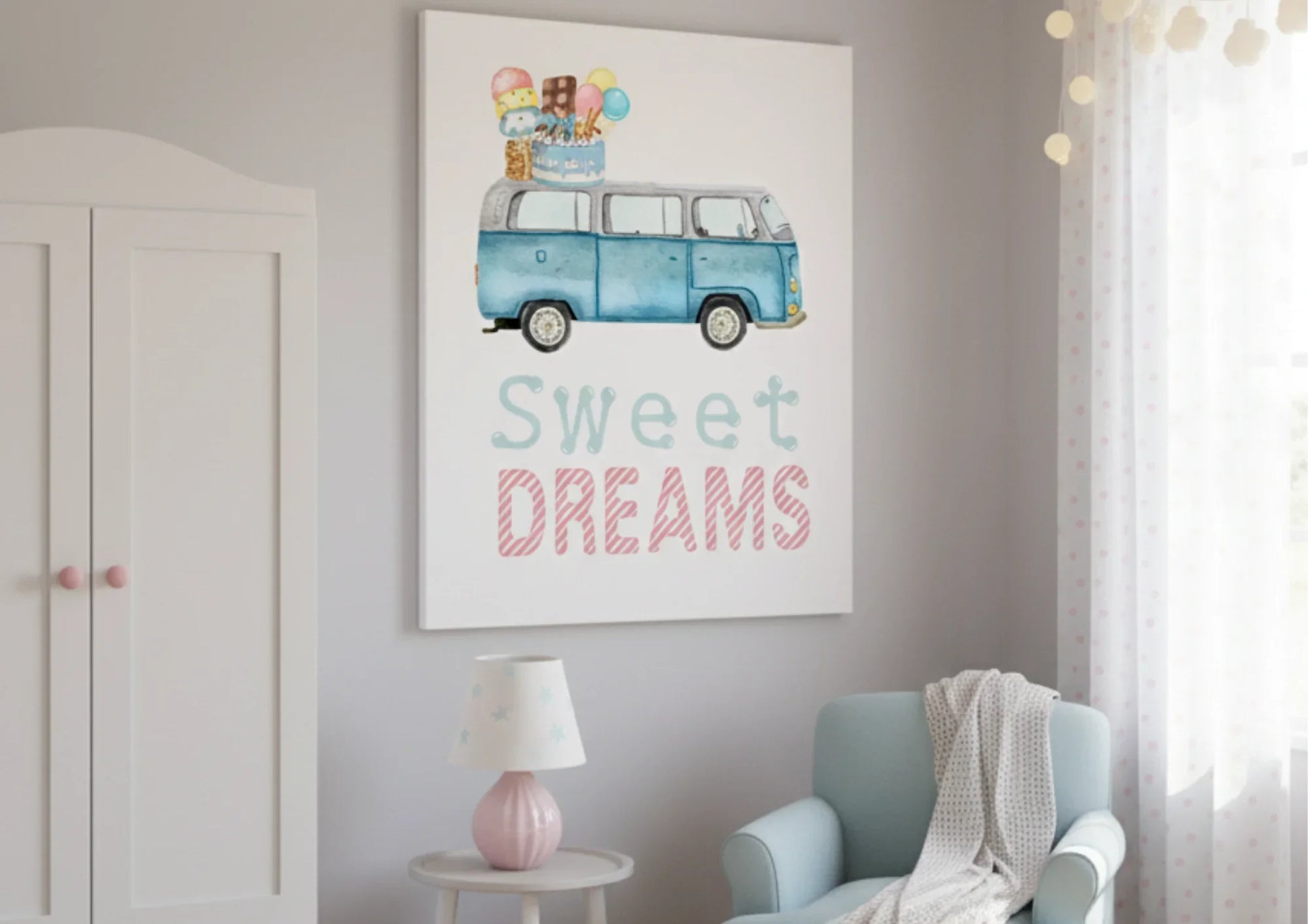 A large watercolor canvas print hangs on a pale gray wall in a child's room. The artwork features a blue, vintage Volkswagen van (VW bus) with a stack of ice cream cones, popsicles, and a birthday cake on its roof. Below the image, the words "Sweet DREAMS" are written in a whimsical font, with "Sweet" in light blue and "DREAMS" in striped pink. To the left, a white wardrobe with pink knobs is partially visible. In the bottom right, a light blue armchair draped with a white knitted blanket sits next to a sma