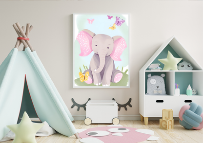 
A framed digital art print of a baby elephant with pink ears and butterflies, hanging on a light beige wall in a child's room. A blue teepee is on the left, and a white, house-shaped bookshelf with toys is on the right. A pink and white checkered rug is on the floor.