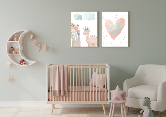 A charming baby girl's nursery featuring a white crib with pink bedding, a cozy armchair, and a crescent moon shelf. On the wall, two framed digital prints depict a cute pink dinosaur with a crown and a watercolor heart, all against a soft sage green wall.