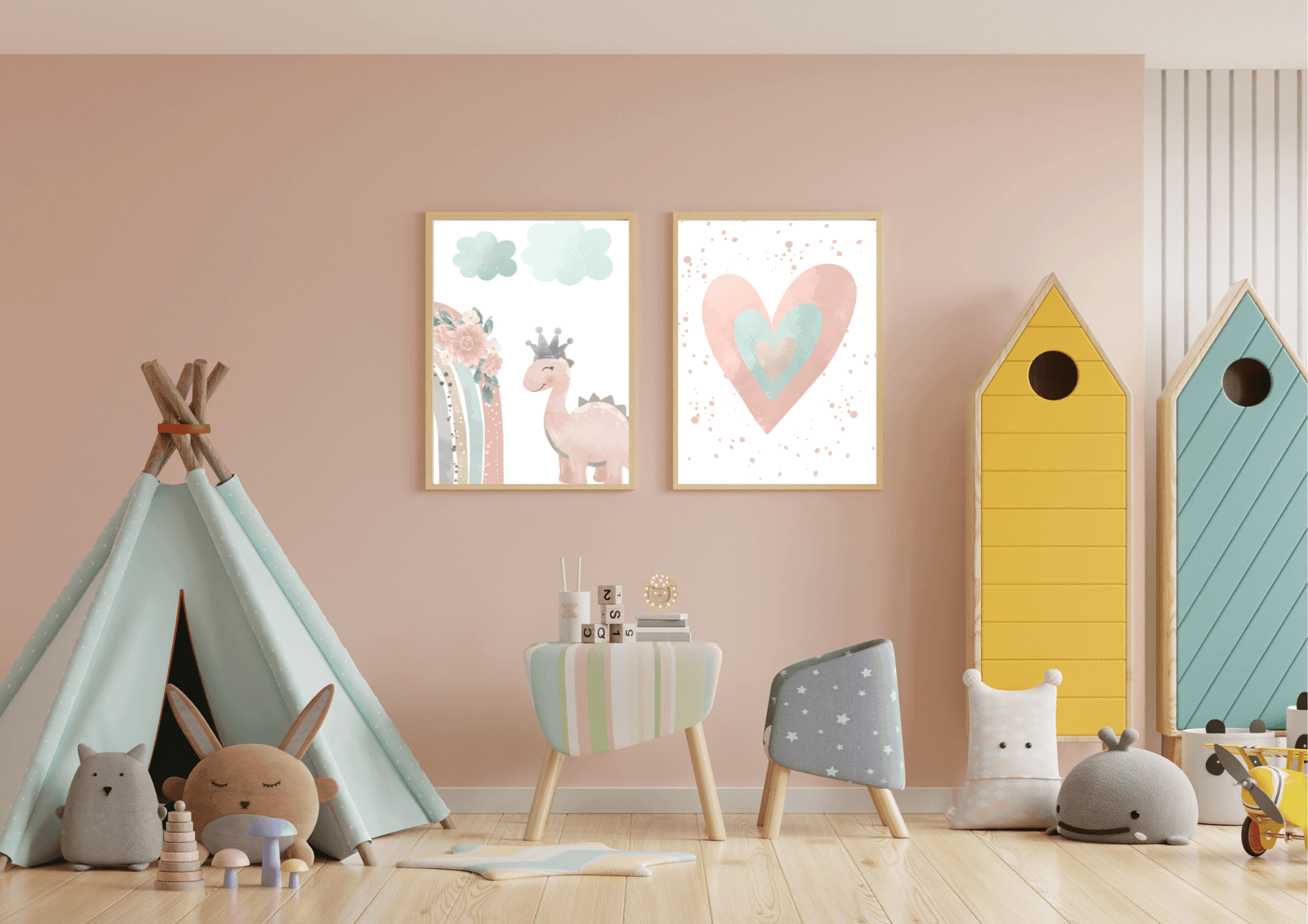 A fun and playful kid's room with a light pink wall. Two framed prints hang above a small table, featuring a watercolor heart and a cute pink dinosaur with a crown. The room also includes a light blue teepee tent, colorful toy houses, and various stuffed animals, creating a cozy and imaginative space.