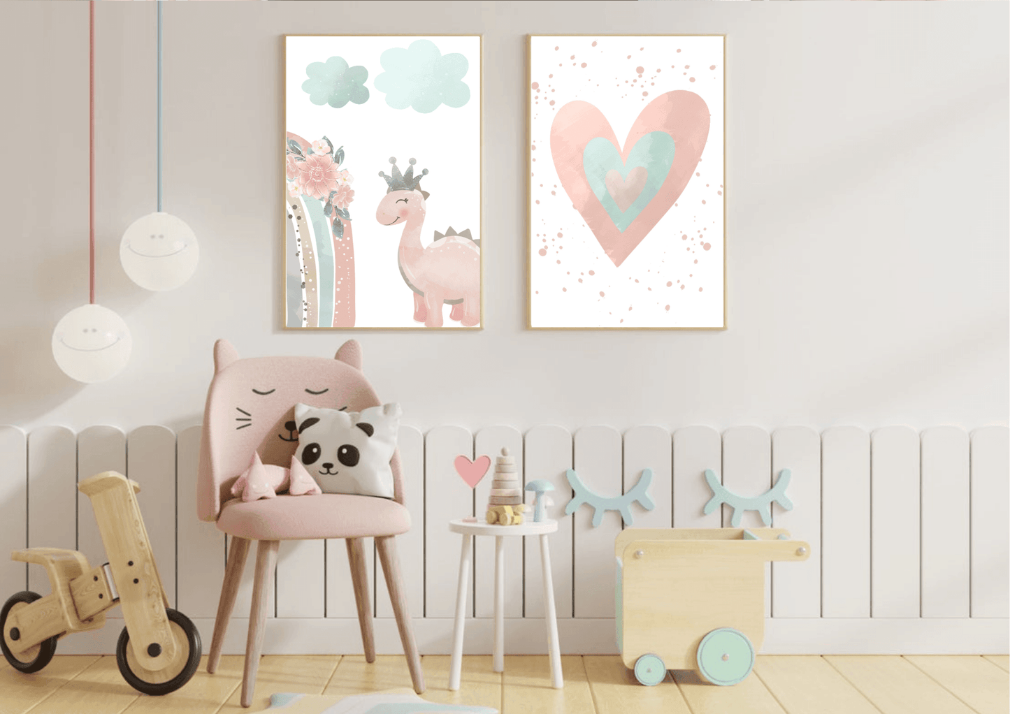 A whimsical kids' room with a white vertical plank wall. Two framed prints hang above a small pink chair with cat ears, depicting a watercolor heart and a cute pink dinosaur with a crown. The room also includes various wooden toys, a small side table, and unique hanging lights, creating a fun and stylish space.