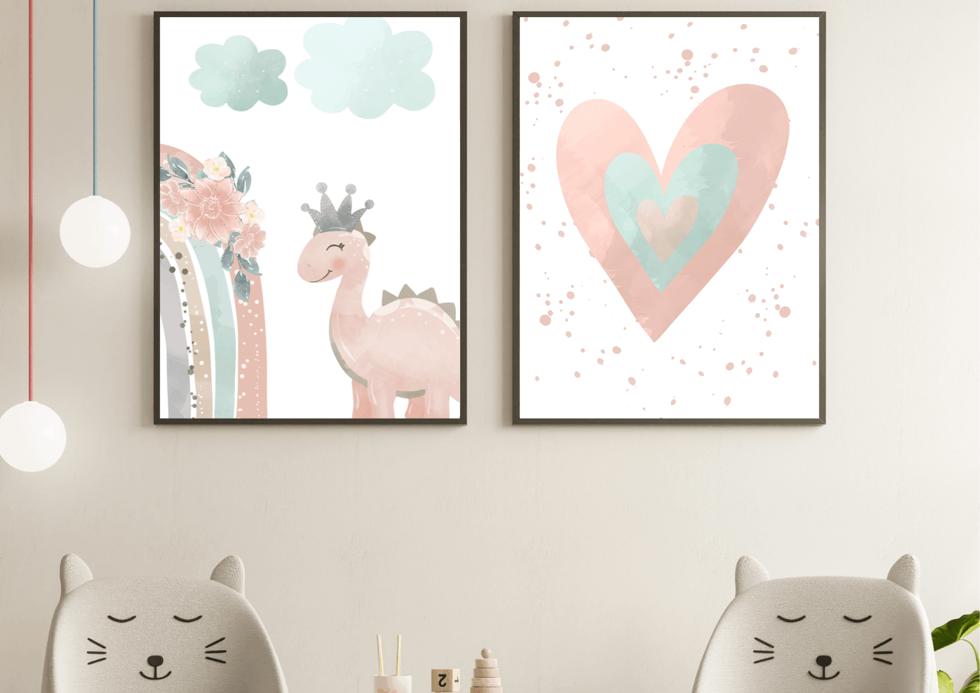 A close-up of a modern nursery featuring two chairs with cat-ear designs. On the wall above them, two framed digital prints depict a watercolor heart and a cute pink dinosaur with a crown, adding a playful and whimsical touch to the room.