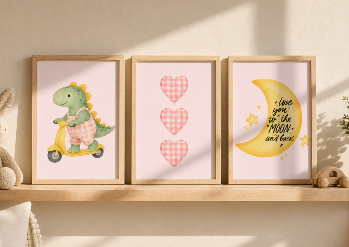 Three framed nursery art prints displayed on a wooden shelf against a warm beige wall. The left print shows a green dinosaur riding a yellow scooter, the center print features three pink gingham hearts, and the right print shows a yellow crescent moon with the text 'love you to the MOON and back' with small yellow stars.