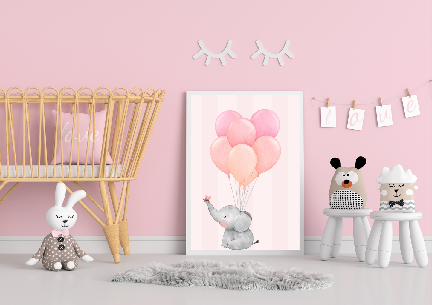 Children's room with pink walls, toys, and a framed picture of an elephant with balloons.