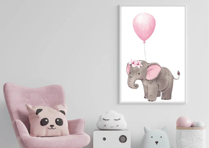 A framed nursery print of a baby elephant with a floral crown holding a pink balloon, hanging on a white wall above a pink armchair with a panda pillow.