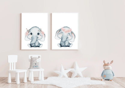A serene nursery room featuring a white wooden crib draped with a soft, sheer canopy. Above the crib, two matching white-framed watercolor elephant prints are hung side-by-side. The grey elephants wear delicate pink flower crowns. The room includes a round rug, natural light, and a small pink stuffed toy on the crib, showcasing a peaceful celestial animal theme in soft pink and grey tones.