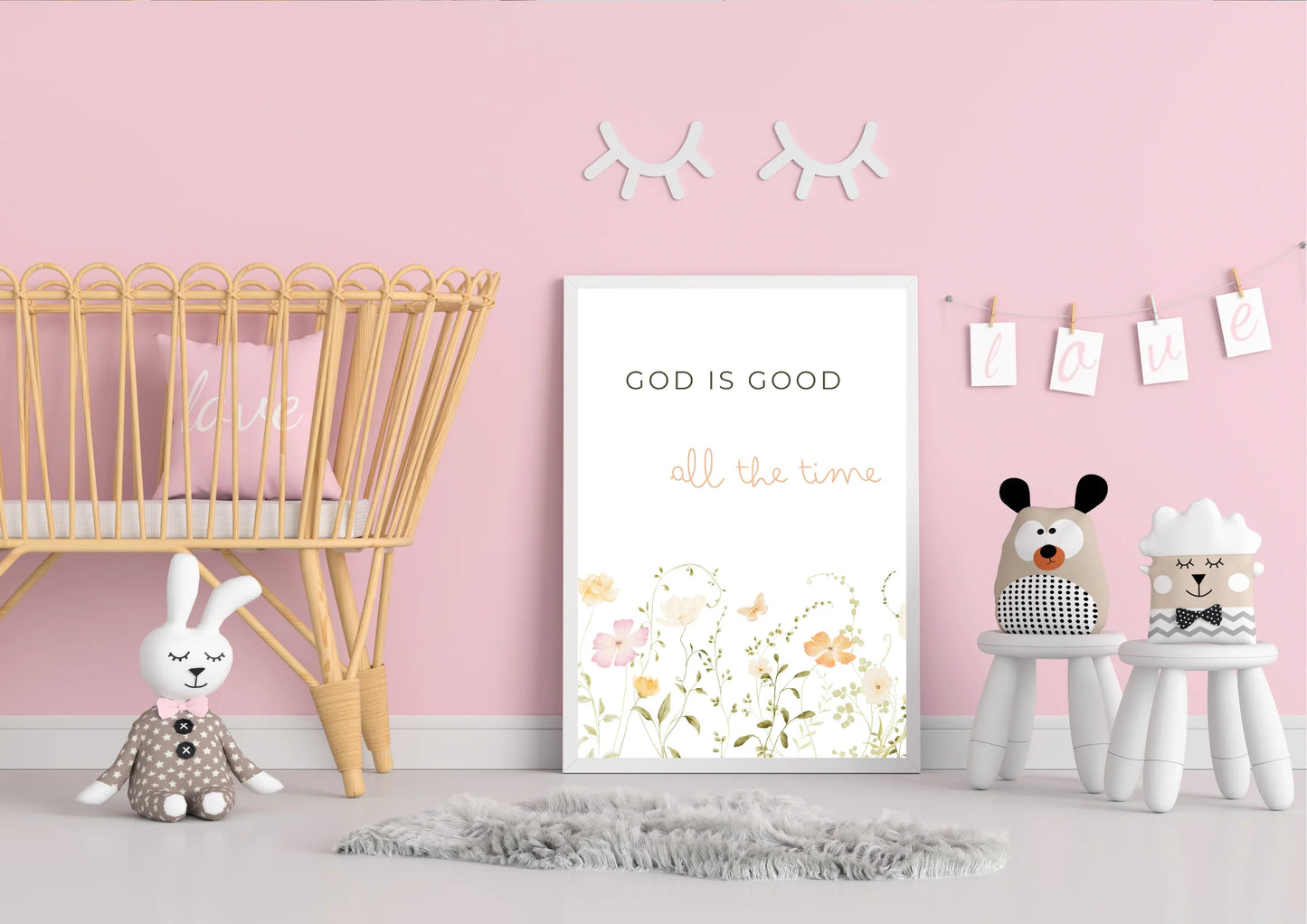 Nursery room with pink walls, wooden crib, and decorative elements.