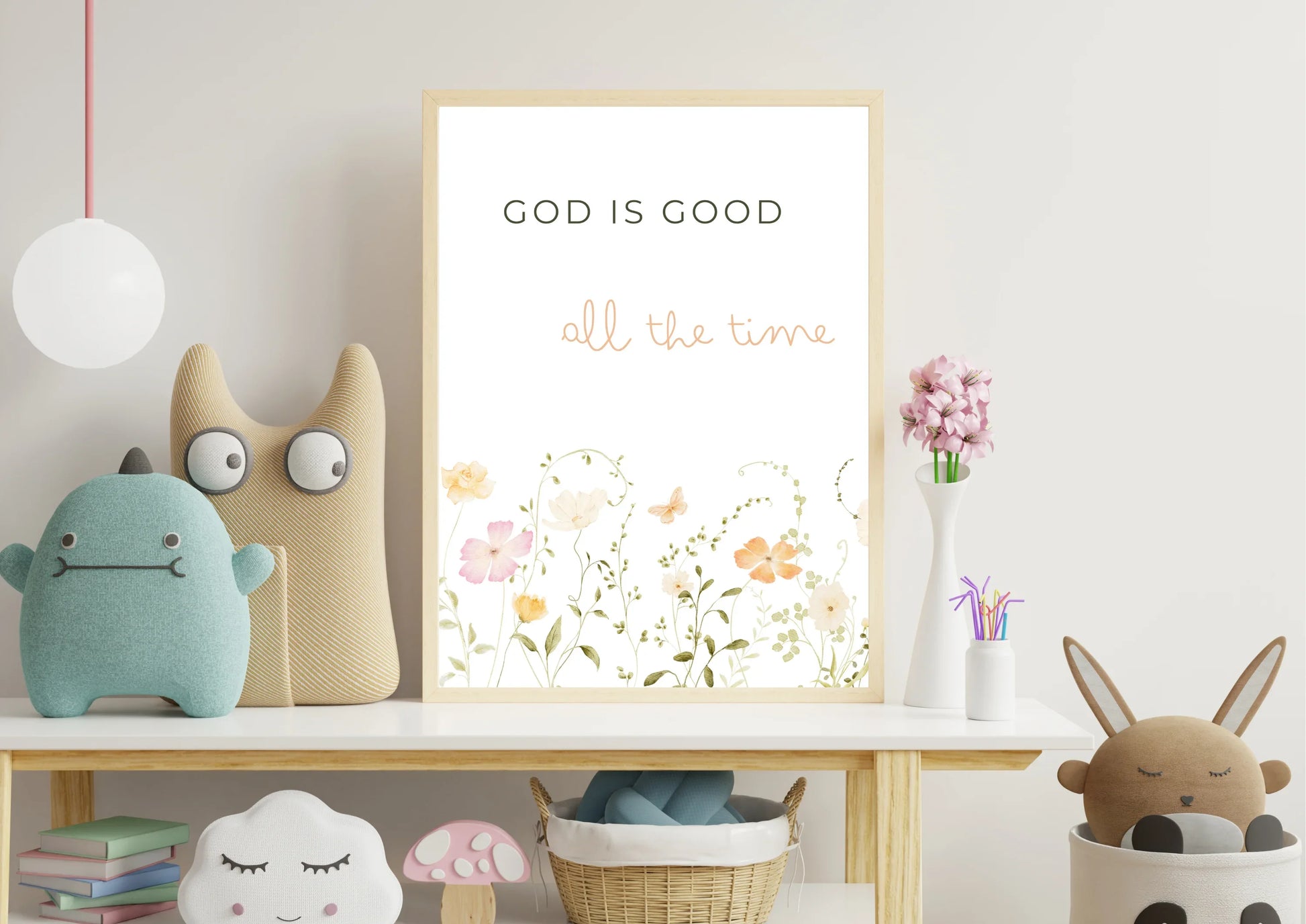 Children's room with plush toys and a 'God is Good' poster.