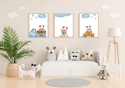 Three framed Farm Cow Nursery Art prints displayed above a low white toy bench in a light, neutral-toned playroom.