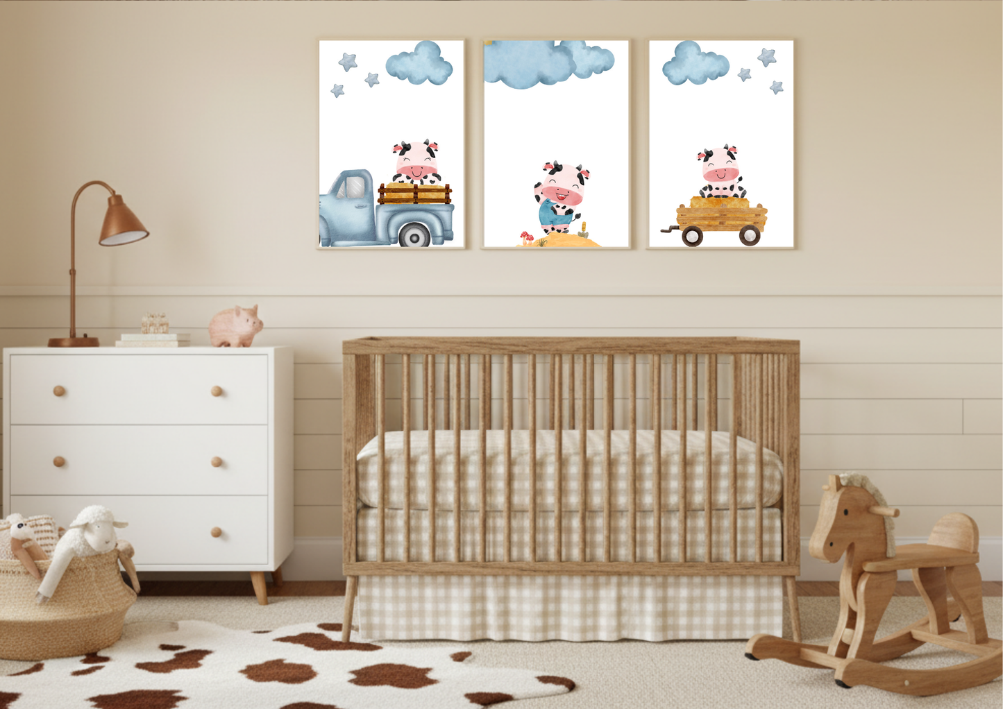 Three framed Farm Cow Nursery Art prints over a wooden crib and white dresser in a nursery with light yellow walls.