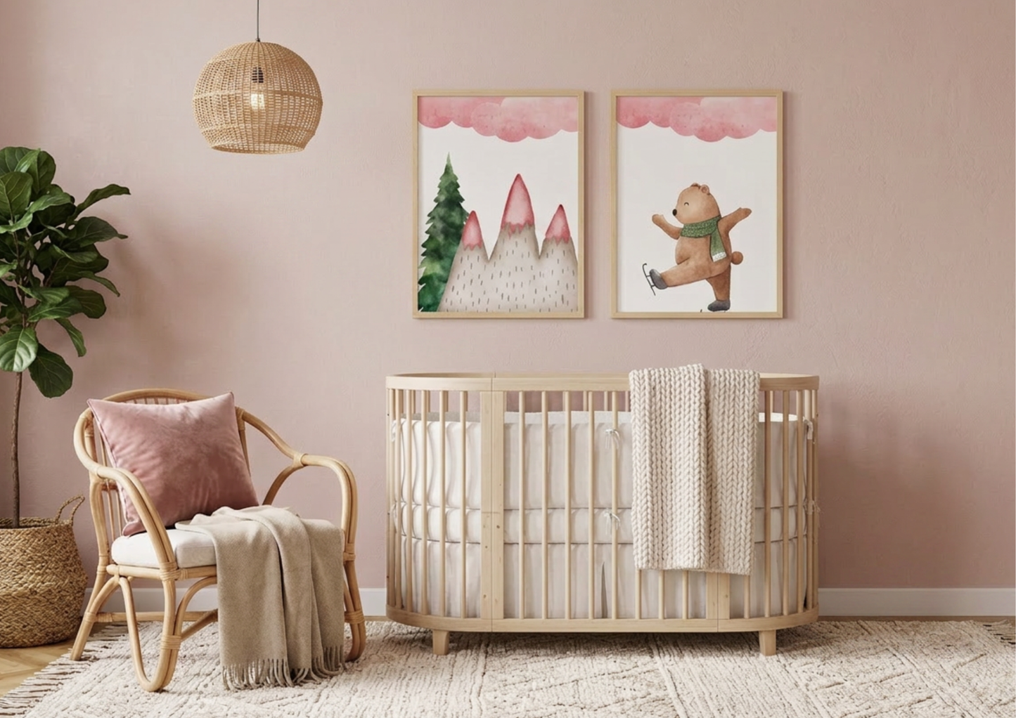 Two framed winter bear watercolor art prints hanging above a light-wood oval crib in a dusty pink nursery.