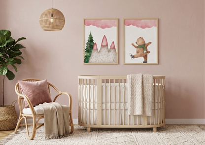 Two framed winter bear watercolor art prints hanging above a light-wood oval crib in a dusty pink nursery.