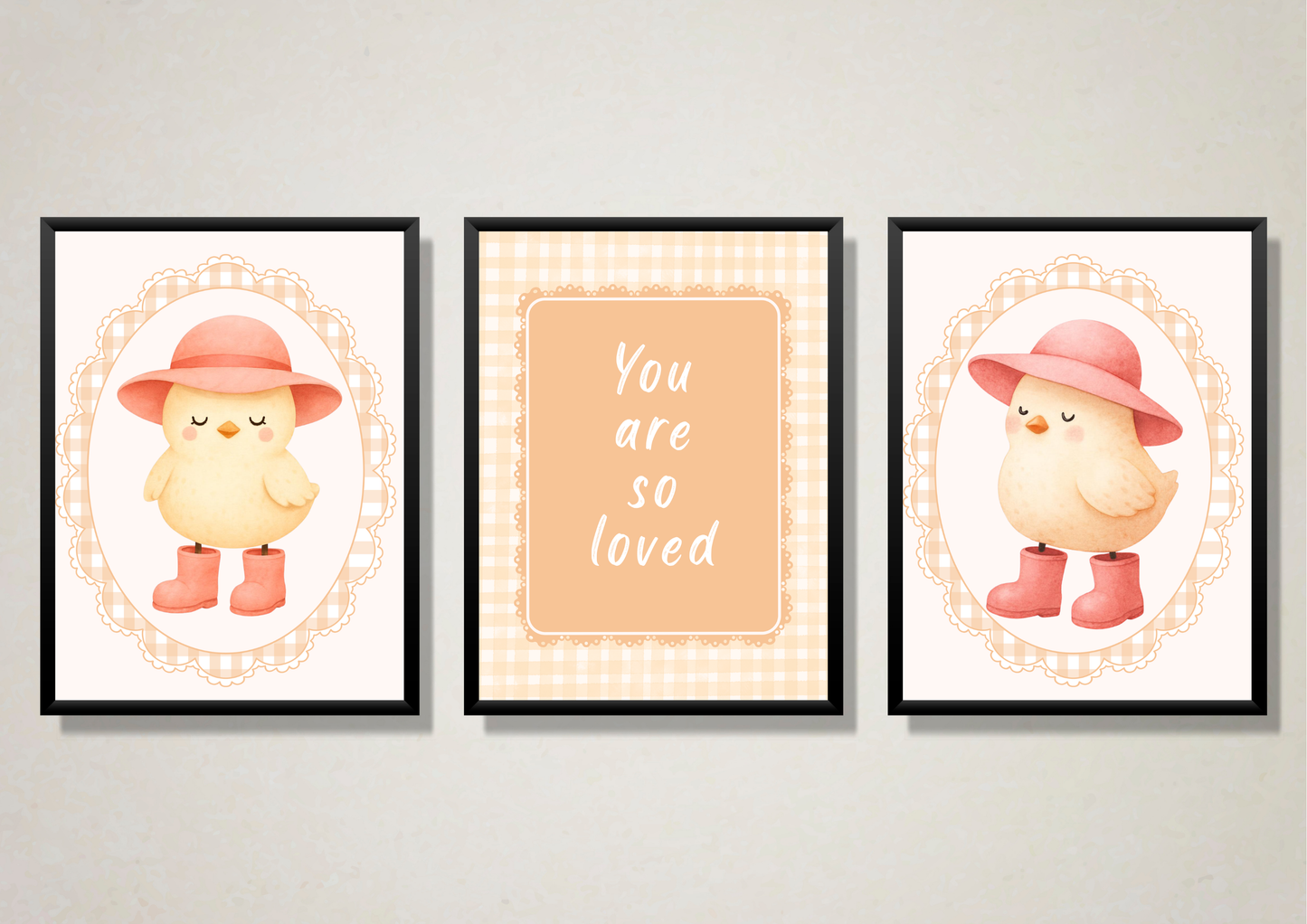 Three framed prints with a chick wearing a hat and boots, and the text 'You are so loved' on a light gray wall.