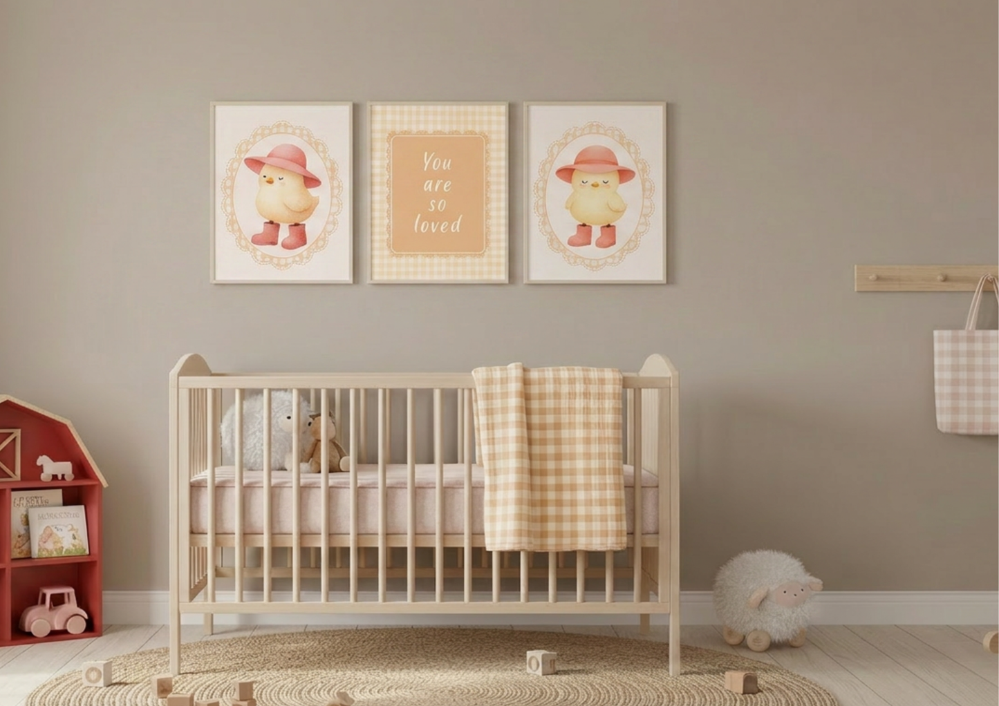 Nursery room with a crib, toys, and framed baby chic pictures on the wall.