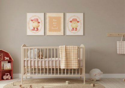 Nursery room with a crib, toys, and framed baby chic pictures on the wall.
