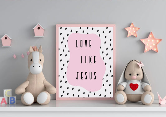 
A pink-framed "Love like Jesus" art print on a shelf with stuffed animals and star lights in a child's room.