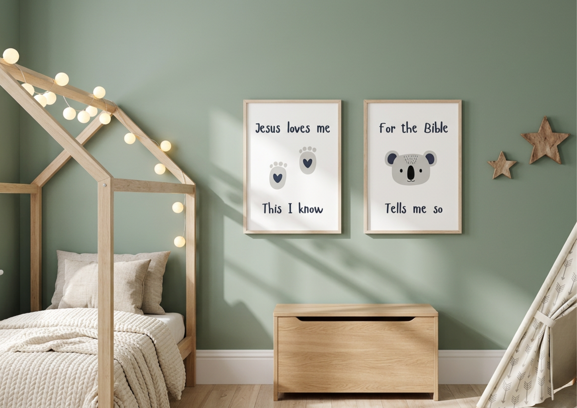 Sage green nursery with "Jesus Loves Me" and koala watercolor framed wall art prints hanging above a wooden toy chest.