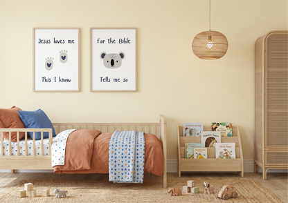Toddler bedroom with "Jesus Loves Me" and koala watercolor framed wall art prints hanging above a terracotta-themed wooden bed.