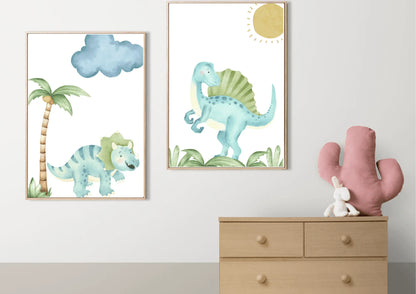 A set of two framed watercolor dinosaur art prints with wooden frames on a white wall above a dresser with a cactus pillow.