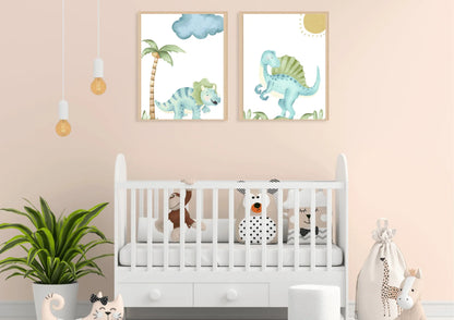 A set of two watercolor dinosaur art prints with wooden frames on a peach wall above a white crib.